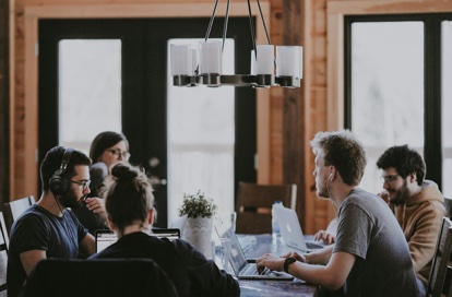 A team meeting around a long table in a bright office